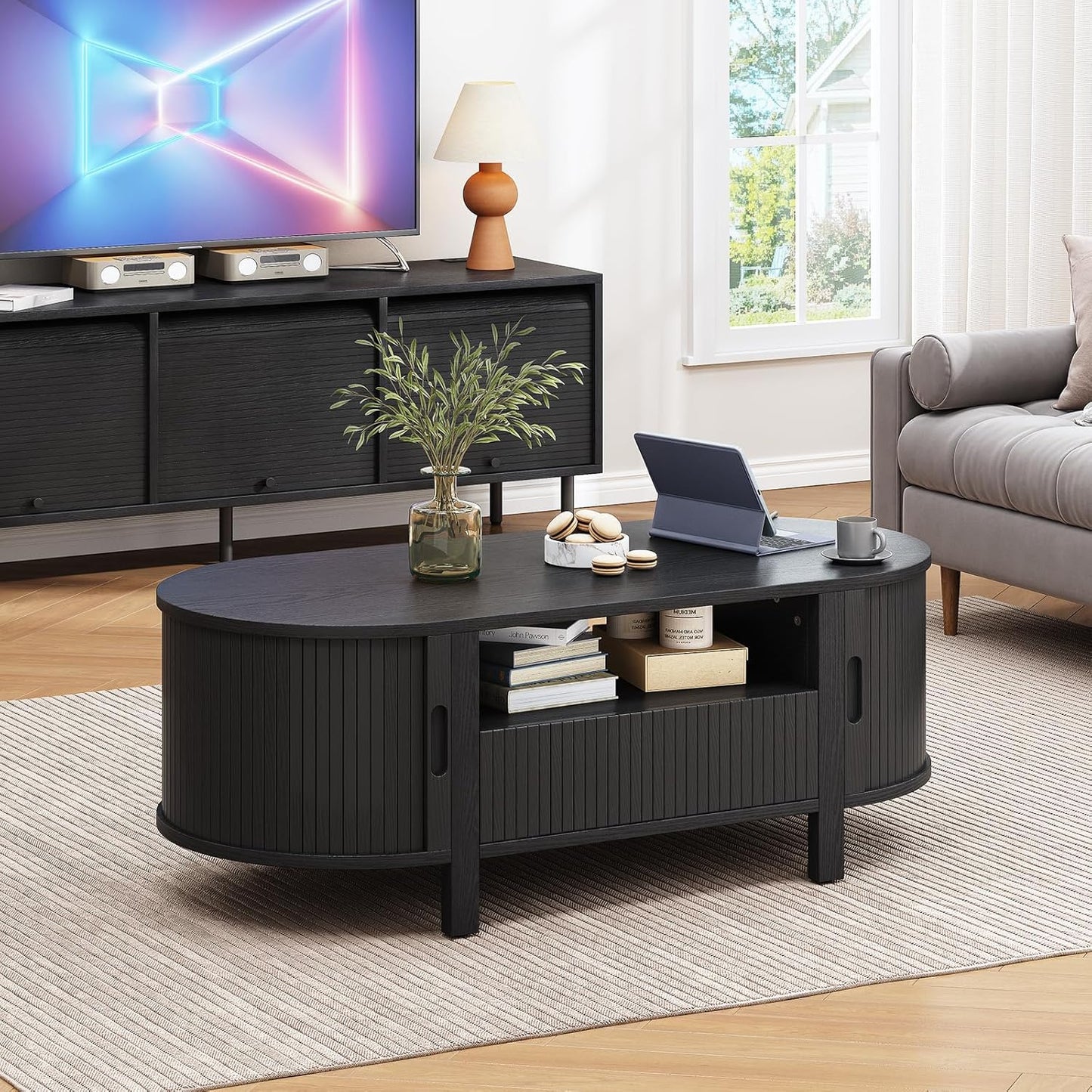 Black mid century oval coffee table with drawer and sliding door, view 7