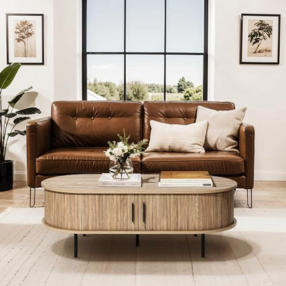 LuxenHome 47" Oval Coffee Table with Storage and Sliding Door | mid century modern style, fluted sliding door, hidden storage space, metal legs