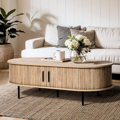 LuxenHome 47" Oval Coffee Table with Storage and Sliding Door | mid century modern style, fluted sliding door, hidden storage space, metal legs