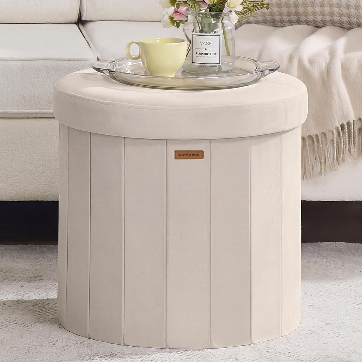SONGMICS Mazie Collection - Round Storage Ottoman, Folding Footrest Stool with Removable Lid, Easy Assembly, Velvet Vanity Stool for Bedroom, Living Room, Entryway, Cappuccino Beige ULSF608L01
