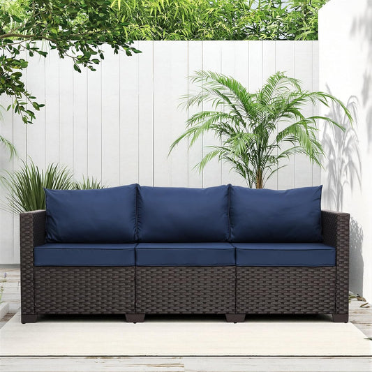 Brown wicker 3 seat outdoor sofa with navy blue cushions