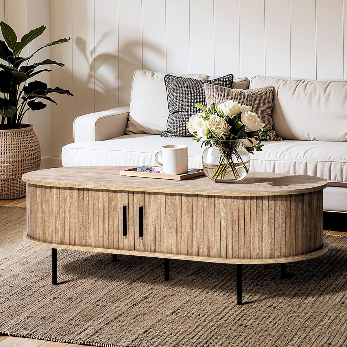 LuxenHome 47" Oval Coffee Table with Storage and Sliding Door | mid century modern style, fluted sliding door, hidden storage space, metal legs
