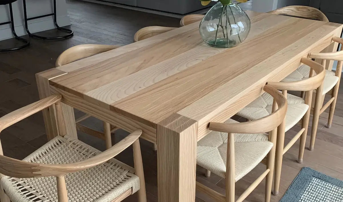 Wooden dining table with chairs in a room setting